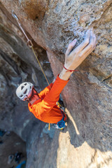 Obraz premium The last movements to reach the summit by a male climber. Rock climbing inside Andes mountains and valleys at Cajon del Maipo, an amazing place to enjoy rock climbing and mountaineering sports, Chile