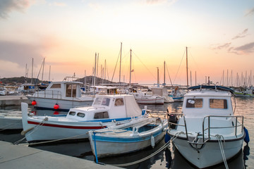 Beautiful white boats moored in the dock at sunset