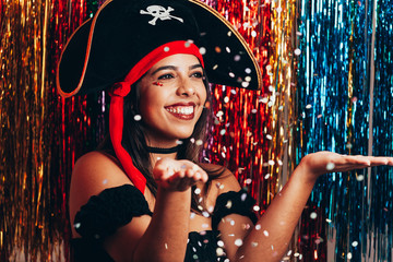 Beautiful young woman having fun with a fake party pirate costume. Brazilian Carnival concept