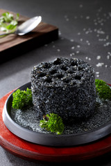 Black fried rice in the shape of honeycomb briquette

