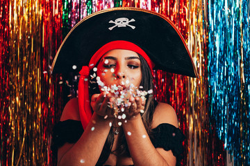 Beautiful young woman having fun with a fake party pirate costume. Brazilian Carnival concept - obrazy, fototapety, plakaty