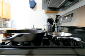 Modern stainless steel gas stove oven in a home with various cookware.
