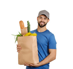 Man holding paper bag with fresh products on white background. Food delivery service
