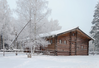 Old wooden house in North Russia, winter time