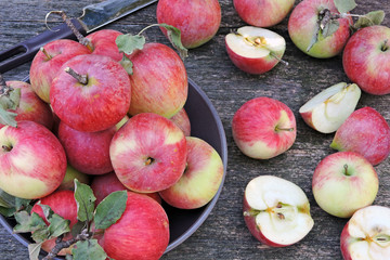 Fresh juicy pink apples on a wooden surface. Apple harvest. Apples, just plucked from the tree.