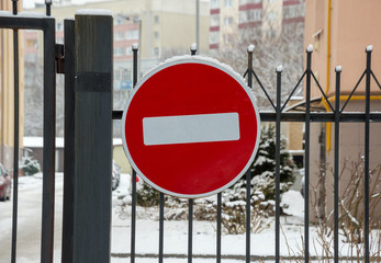 Snow-covered road sign STOP close-up on a white background on a winter afternoon
