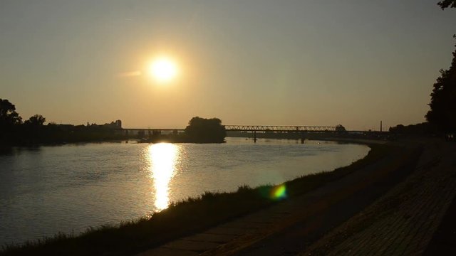Golden sunset over the river. Peaceful sunset over river Sava in Brod, Croatia. View of the beautiful golden sunset in summer. Bridge on Sava river 