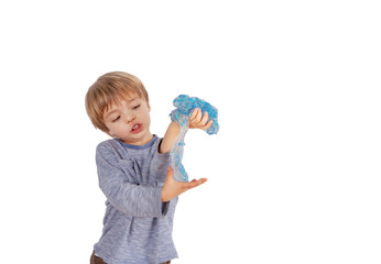 Cute small boy playing with glitter slime. Studio shot, isolated on white background.