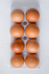Red chicken eggs on a white background.