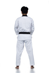 Master Black Belt TaeKwonDo handsome man instructor Teacher fighter show hit pose, studio lighting white background isolated.  White formal fighting suit, motion blur hand foots on taekwondo post.