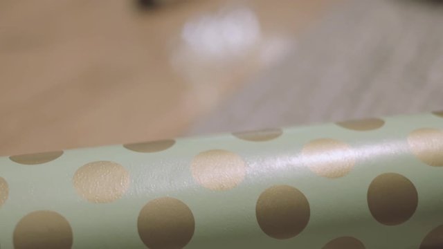 B roll of wrapping paper on the floor of a decorated home.