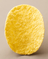 Close-up of potato chips, on solid color background