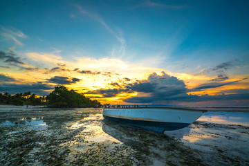 Wooden boat with sunset background