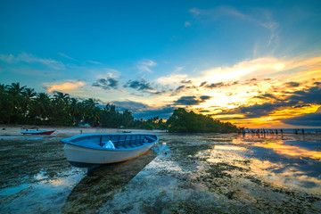 Fototapeta na wymiar Wooden boat with sunset sky background