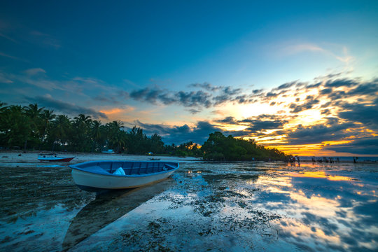 Wooden boat with sunset background