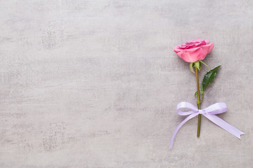 Flowers valentine day composition. Frame made of pink rose on gray background. Flat lay, top view, copy space.