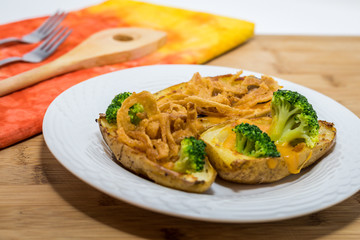 Potato Skins appetizer with broccoli, cheddar cheese and fried onions