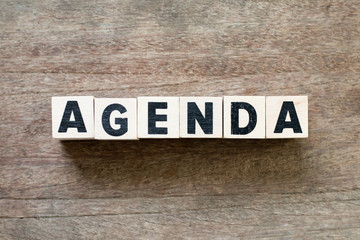 Obraz premium Letter block in word agenda on wood background