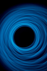 Light Painting Photo of Blue Spirals - Circling Out from the Center with a Deep Black Background