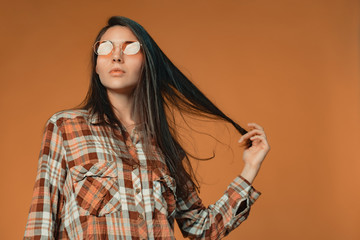 Longhaired young brunette gir with facial acne looking offended