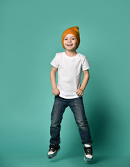 Image of little boy child jumping isolated over green background. © FAB.1