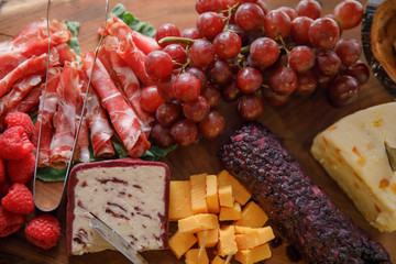 Charcuterie board of meats, cheeses and fruit