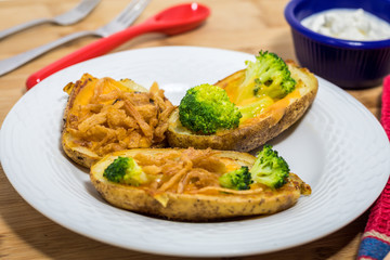 Potato Skins appetizer with broccoli, cheddar cheese and fried onions