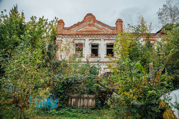 Fototapeta na wymiar Abandoned overgrown ruined house