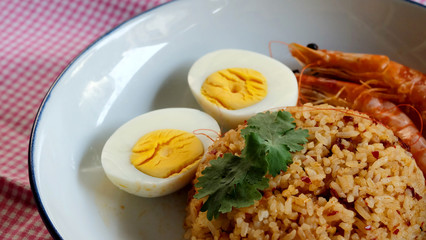 Thai chili paste fried rice, boiled egg and sweet shrimp on white plate and space for write wording, easy cook meal for home making or served in restaurant, popular for foreigner or tourist