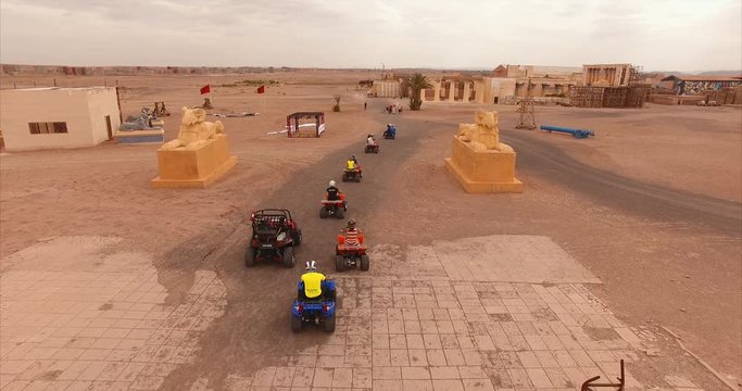 Aerial shot following close behind a group of quads in the desert of Ouarzazate (Morocco)