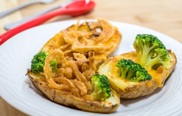 Potato Skins appetizer with broccoli, cheddar cheese and fried onions