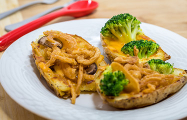 Potato Skins appetizer with broccoli, cheddar cheese and fried onions