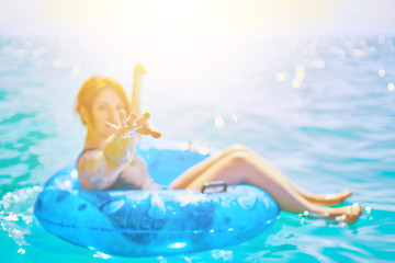 Woman relax on inflatable ring in sea