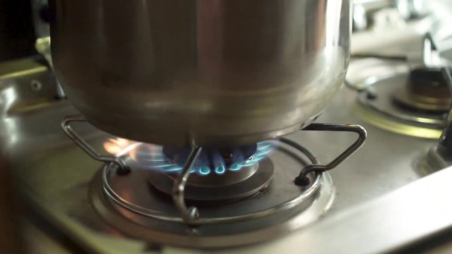 Close up - Lighting up gas stover burner fire and a pot in a campervan