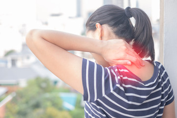 Asian Woman with muscle injury having pain in her neck.