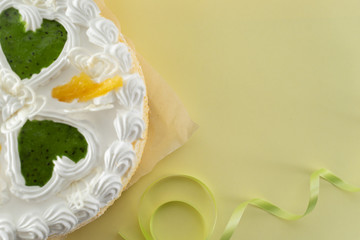 white cake on a colored background with ribbons shot from above