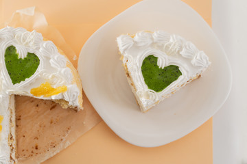 white cake on a colored background with ribbons shot from above