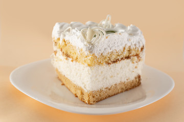 piece of cake on a white plate shot from the side