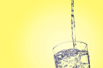 Water falling in glass on isolate background.