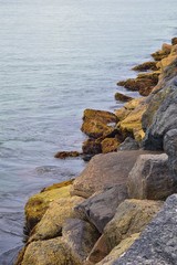 View from Mission Beach in San Diego, of Piers, Jetty and sand, around surfers, including warning signs, palm trees, waves, rocks, boats and horizon views. Pacific Ocean. California, United States.