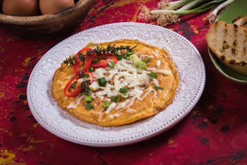 Omelet, fried chicken eggs with fresh vegetables