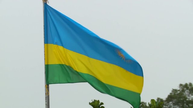 Real textile Flag Waving against The Sky of Kigali in Rwanda