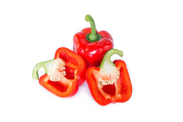 red bell pepper cut into pieces on white background, top view.