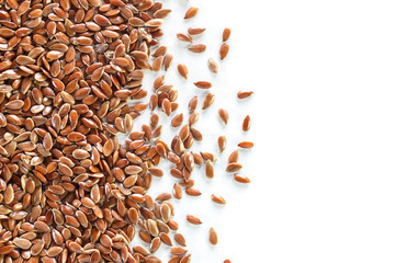 Brown flax seed on white background.