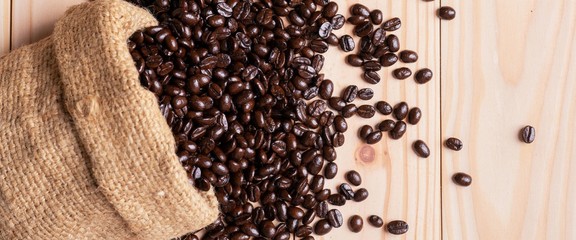 .Coffee beans spilled out from linen sack