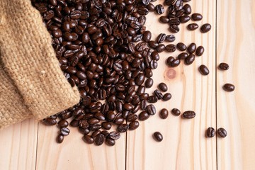 .Coffee beans spilled out from linen sack