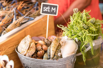Nicely placed shrimp, mussels, seafood on ice in a bucket. Dining.