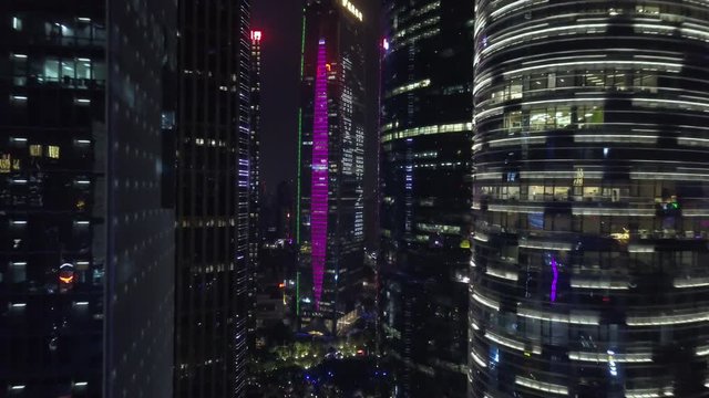 Asia, China. Guangzhou metropolis downtown at night with illumination and reflections on the buildings.