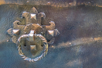Iron lock of an ancient door in an antique fortress close-up