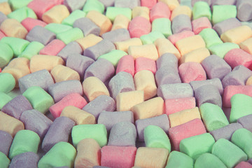 Multicolored marshmallow pads background, select focus.